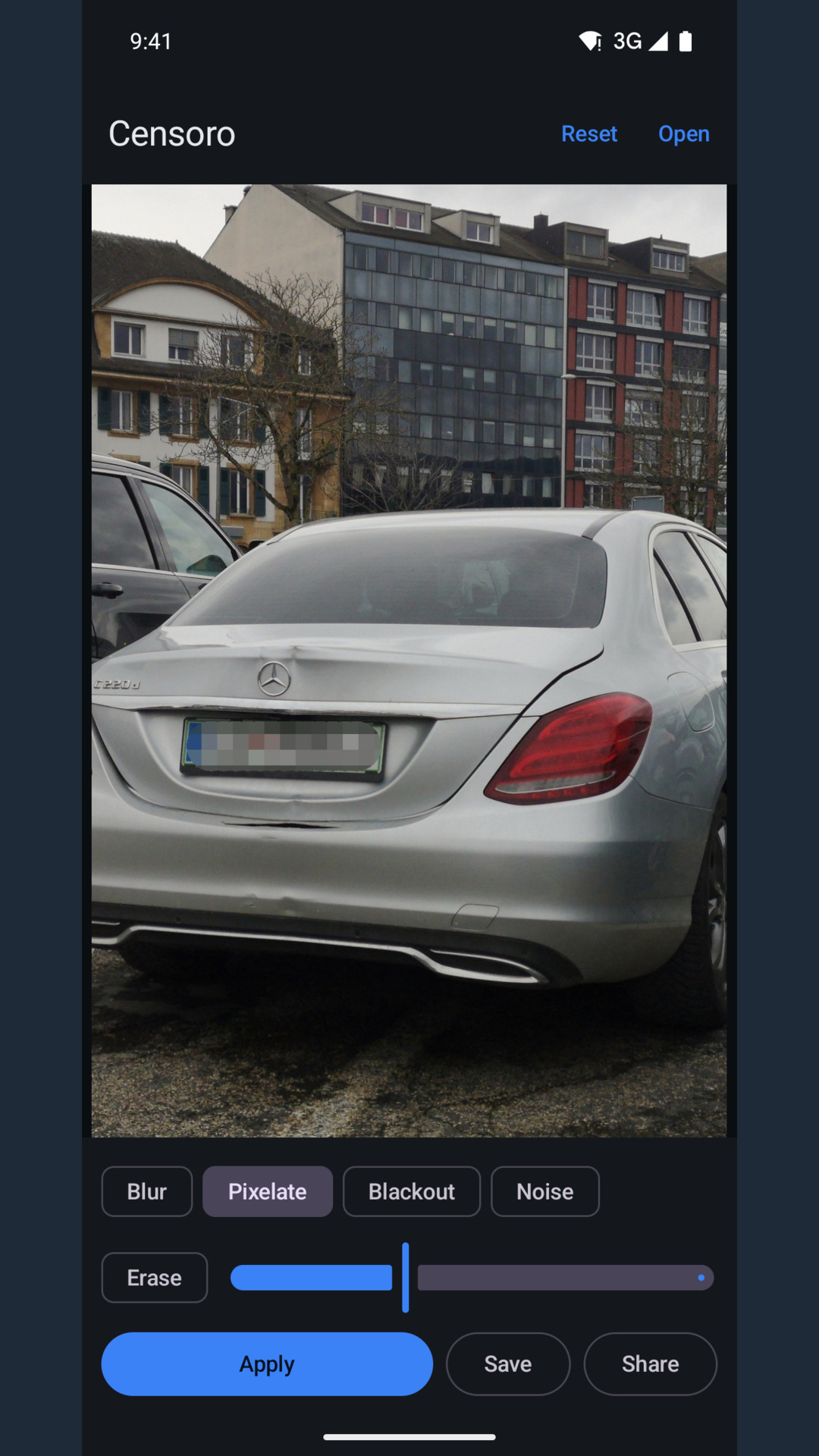 The same car after Apply: the plate is a block mosaic, the rest of the photo is unchanged.
